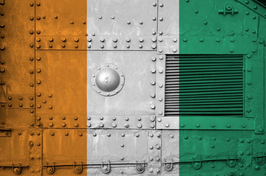 Ivory Coast flag depicted on side part of military armored tank close up